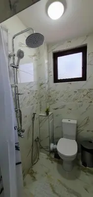 a bathroom with a toilet and a shower at АПАРТАМЕНТ ЮЛИЯ ДЕЛУКС II in Velingrad