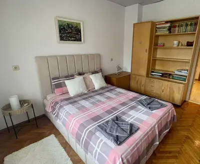 a bedroom with a bed with a pink andkered blanket at Apartment Maddie in Teteven