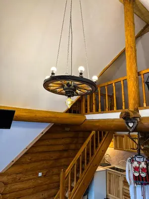 a chandelier hanging from a wooden ceiling in a house at Lambievi Kolibi in Gorno Kraishte