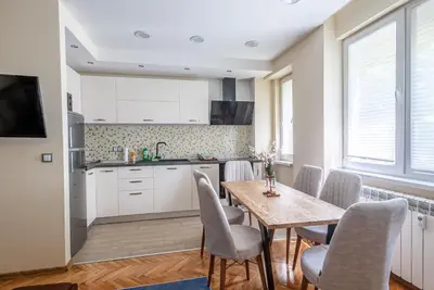 a kitchen and dining room with a table and chairs at Top Center Retreat, Close to Main street, FREE Parking in Sofia