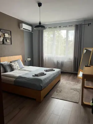 a bedroom with a large bed and a window at Brand NEW! 2BDR Lux Apartment RAYKO in Sofia