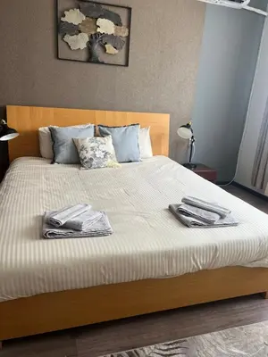 a bedroom with a bed with two towels on it at Brand NEW! 2BDR Lux Apartment RAYKO in Sofia