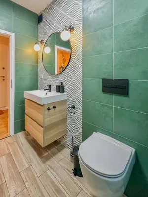 a bathroom with a toilet and a sink and a mirror at Bohemian Hideaway Historic Center Sofia Parking in Sofia