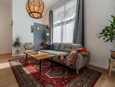 a living room with a couch and a table at Bohemian Hideaway Historic Center Sofia Parking in Sofia