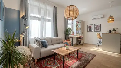 a living room with a couch and a table at Bohemian Hideaway Historic Center Sofia Parking in Sofia