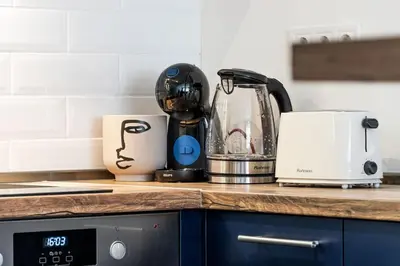 a kitchen counter with a blender on a counter top at Cozy Apartment Overlooking The Park in Sofia