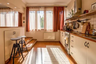 a kitchen with white cabinets and a stove at Home in Sofia's Beating Heart in Sofia