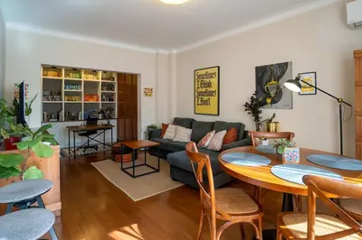 a living room with a table and a couch at Home in Sofia's Beating Heart in Sofia
