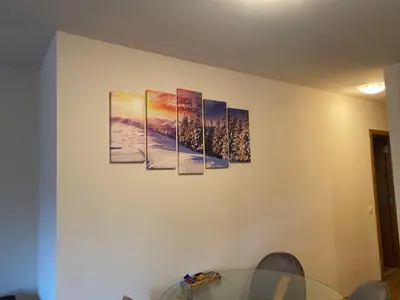 a room with four paintings on the wall at Pamporovo mountain apartment in Pamporovo
