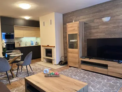 a living room with a large flat screen tv at Pamporovo mountain apartment in Pamporovo