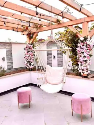 a hammock in a pavilion with two pink chairs and flowers at Boris House 5 bed Villa & Private Pool in Strumyani