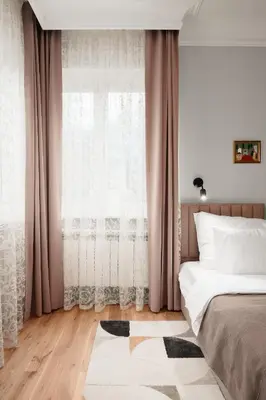 a bedroom with a bed and a large window at Brand New 2 bdr Luxury Apartment in Top Centre in Sofia
