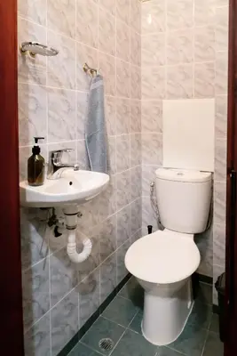 a bathroom with a toilet and a sink at Домът на архитекта The Architect's Home in Plovdiv