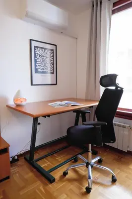 an office with a wooden desk and a chair at Домът на архитекта The Architect's Home in Plovdiv