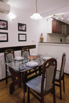 a dining room with a table and chairs and a kitchen at Домът на архитекта The Architect's Home in Plovdiv