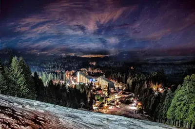 a painting of a resort on a mountain at night at JESY apartment,Borovets Gardens in Borovets