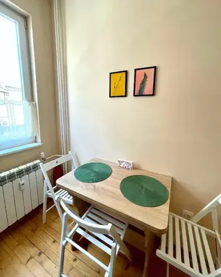 a dining room table with two green plates on it at Bohemian Bright & Calm 2BR - Top center - Private Balcony in Sofia