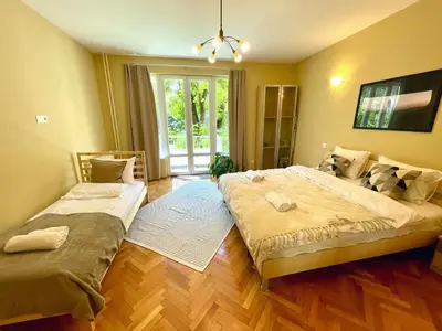 a bedroom with two beds and a large window at Bohemian Bright & Calm 2BR - Top center - Private Balcony in Sofia