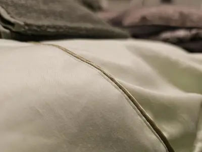 a close up of the edge of a white blanket at Bright Inn - Holiday & Business Apartment in Sofia