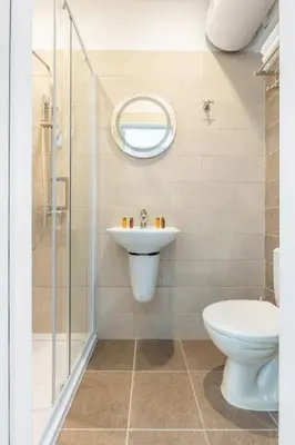 a bathroom with a toilet sink and a shower at Millennia Hotel in Sofia
