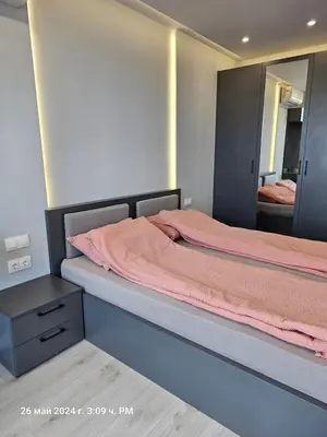 a bedroom with a bed and a large mirror at Dilyanka 2 in Pernik