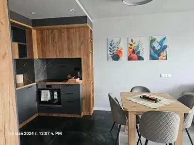 a kitchen with a table and a stove at Dilyanka 2 in Pernik
