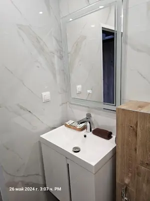 a white bathroom with a sink and a mirror at Dilyanka 2 in Pernik