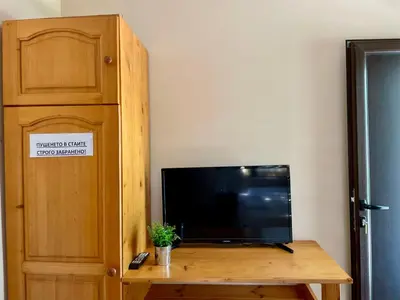 a flat screen tv sitting on top of a wooden table at Bungalows of Yug in Kyustendil