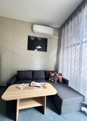 a living room with a couch and a table at Flower house 6 in Sofia