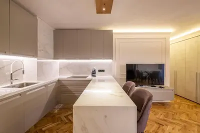 a kitchen with a white counter and a fireplace at SOFapart Stylish & Fancy Place with 1 BDR in Sofia