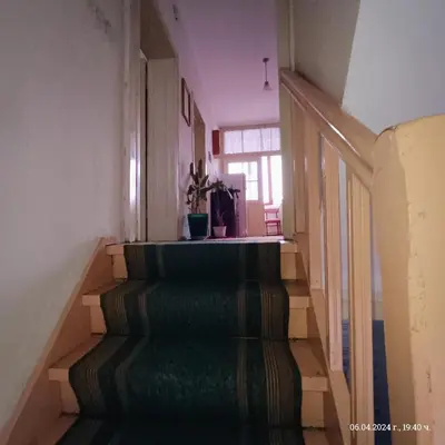 a staircase in a house with a green carpet at Стаи за гости Божана in Razlog