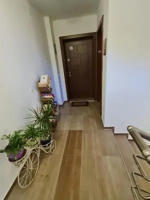 a hallway with a door and some plants and a bike at Cozy studio with balcony in Sofia