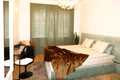 a bedroom with a bed and a table and a chair at Dom Knipituga in Sofia