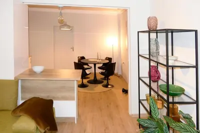 a living room with a table and chairs in a room at Dom Knipituga in Sofia