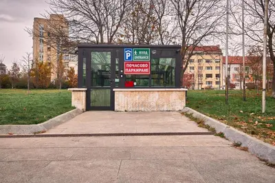 a bus stop with a parking sign in a park at Dom Knipituga in Sofia