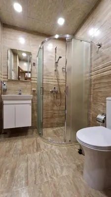 a bathroom with a shower and a toilet and a sink at Апартаменти Недялкови I in Sandanski