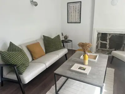 a living room with a couch and a coffee table at Rodopi Mountain Village House in Narechen