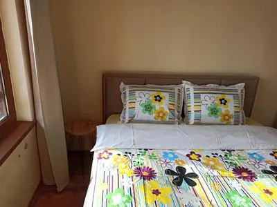 a bed with a bunch of pillows on it at Роси Студио Банско in Bansko