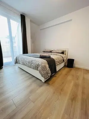a bedroom with a bed and a wooden floor at Sandanski escape in Sandanski