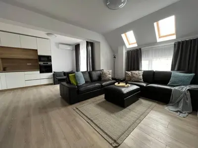 a living room with a black couch and a table at Sandanski escape in Sandanski