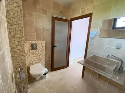 a bathroom with a toilet and a sink at D Villa in Mineralni Bani
