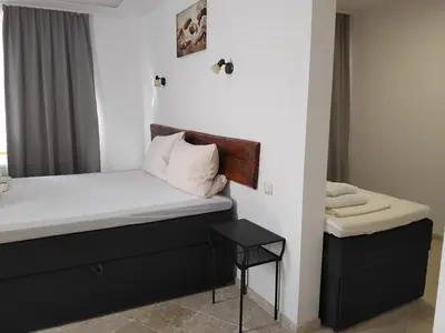 a bedroom with a bed and a small table at D Villa in Mineralni Bani