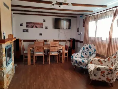 a living room with a dining room table and chairs at Kalina i Sokol spa in Pchelin