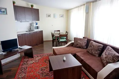 a living room with a couch and a table at GT Aspen House Apartments in Bansko