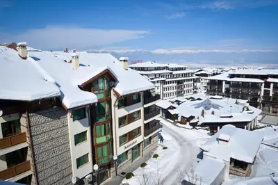a city with snow covered roofs and buildings at GT Aspen House Apartments in Bansko