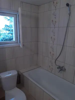 a bathroom with a tub and a toilet and a shower at Easy rooms in Sapareva Banya