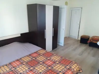 a bedroom with a bed and a cabinet and a door at Easy rooms in Sapareva Banya