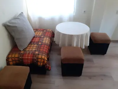 a living room with a couch and a table at Easy rooms in Sapareva Banya