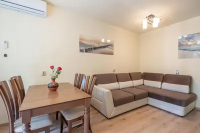 a living room with a couch and a table at Top Location, Brand New 3 BDRM Apt & Free parking in Sofia