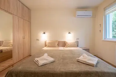 a bedroom with a large bed with two towels on it at Top Location, Brand New 3 BDRM Apt & Free parking in Sofia